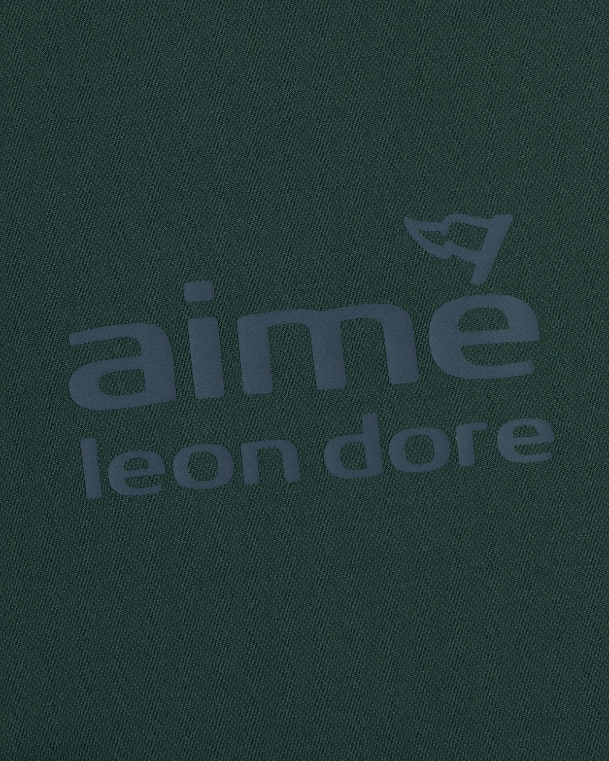 Dark green ALD Golf Tour Polo with gray aimé leon dore logo and a small flag above the letter "e".