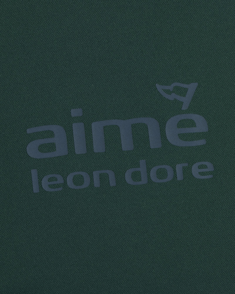 Dark green ALD Golf Tour Polo with gray aimé leon dore logo and a small flag above the letter "e".