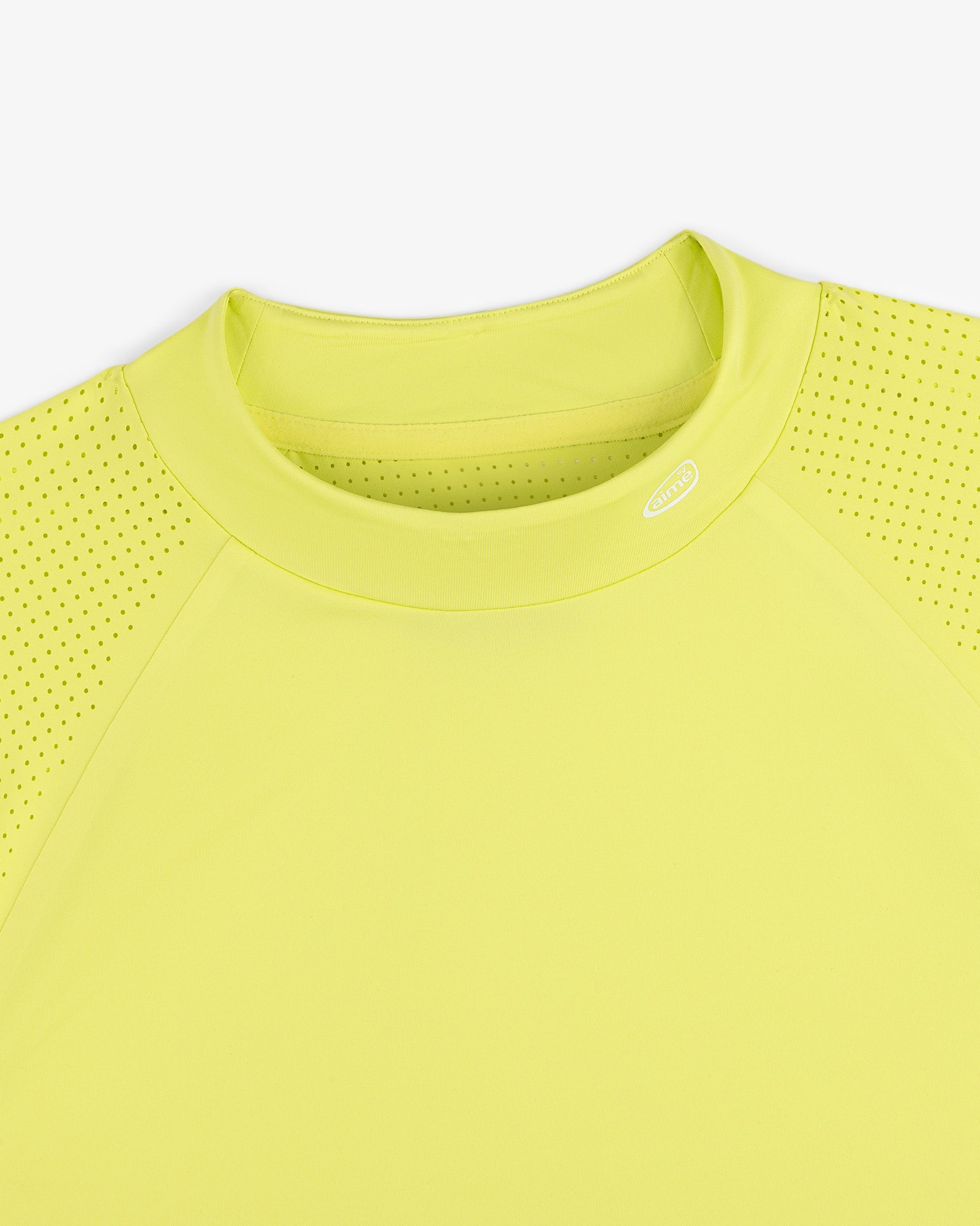 ALD Golf Performance Tee in bright yellow with perforated sleeves, shown neck down on a white background.