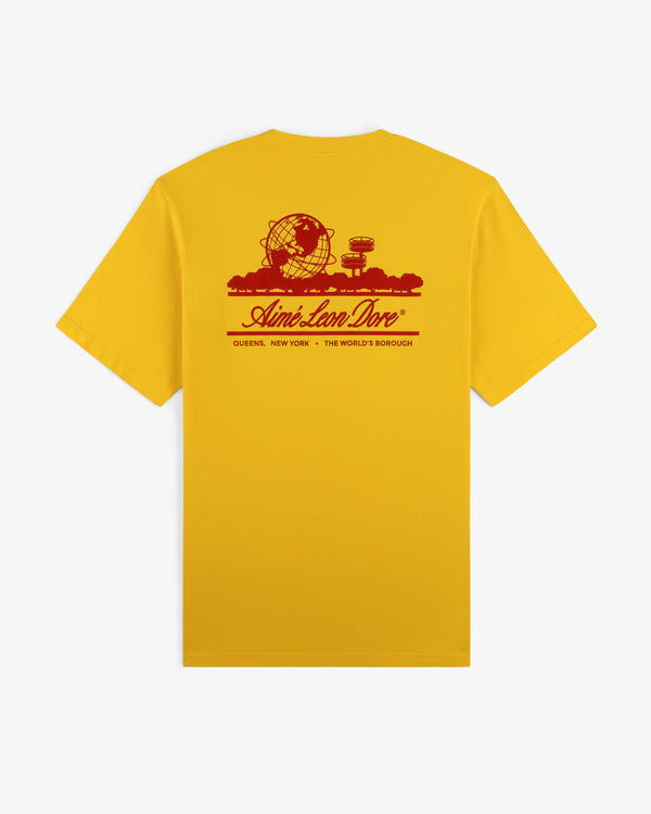 The Sun Faded Unisphere Tee is a yellow shirt with a red Unisphere graphic, trees, and Aimé Leon Dore Queens text.