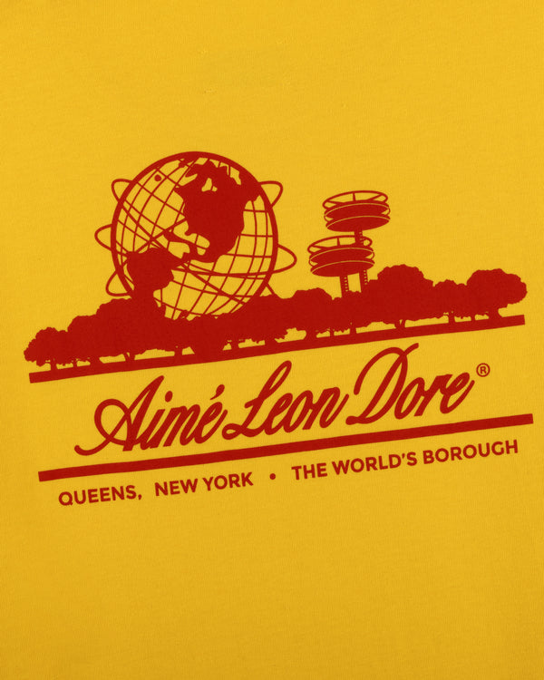 Sun Faded Unisphere Tee featuring a red globe, trees, and towers with Aimé Leon Dore, Queens, NY on yellow background.