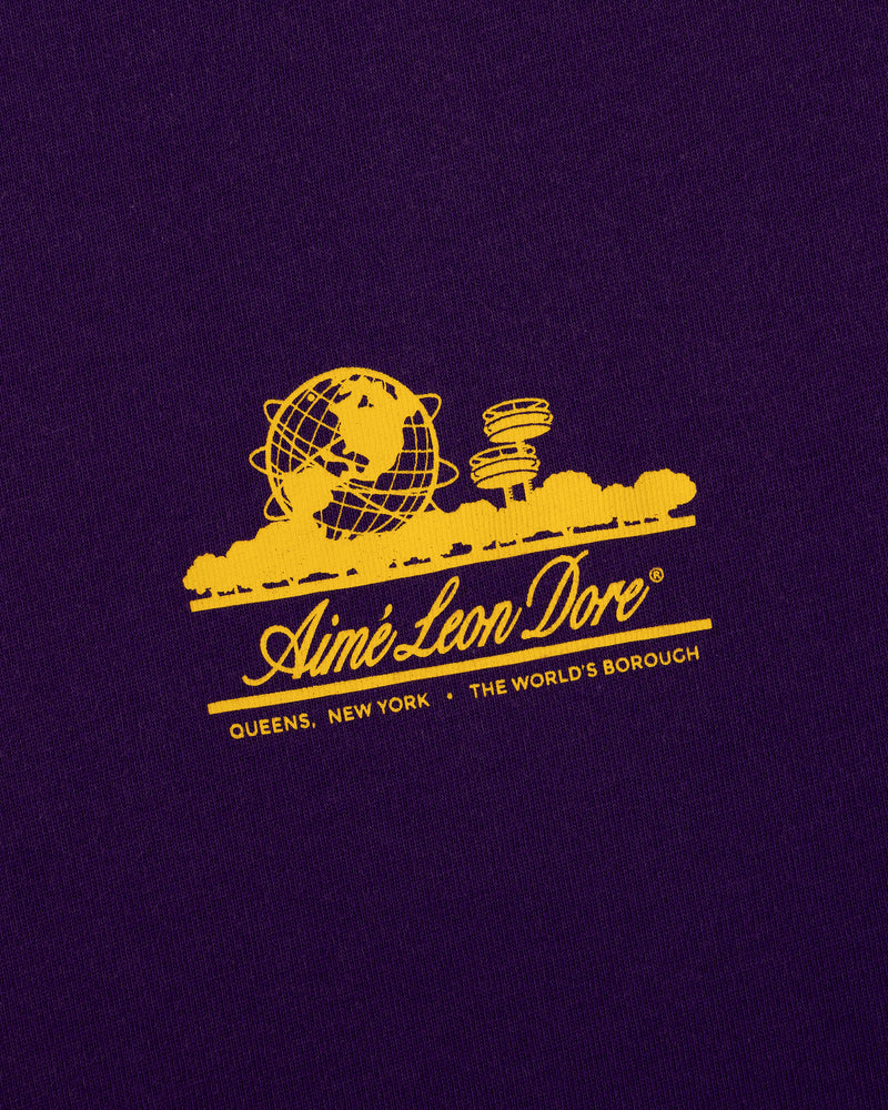 Yellow graphic of the Unisphere and towers with Aimé Leon Dore text on the Sun Faded Unisphere Tee.