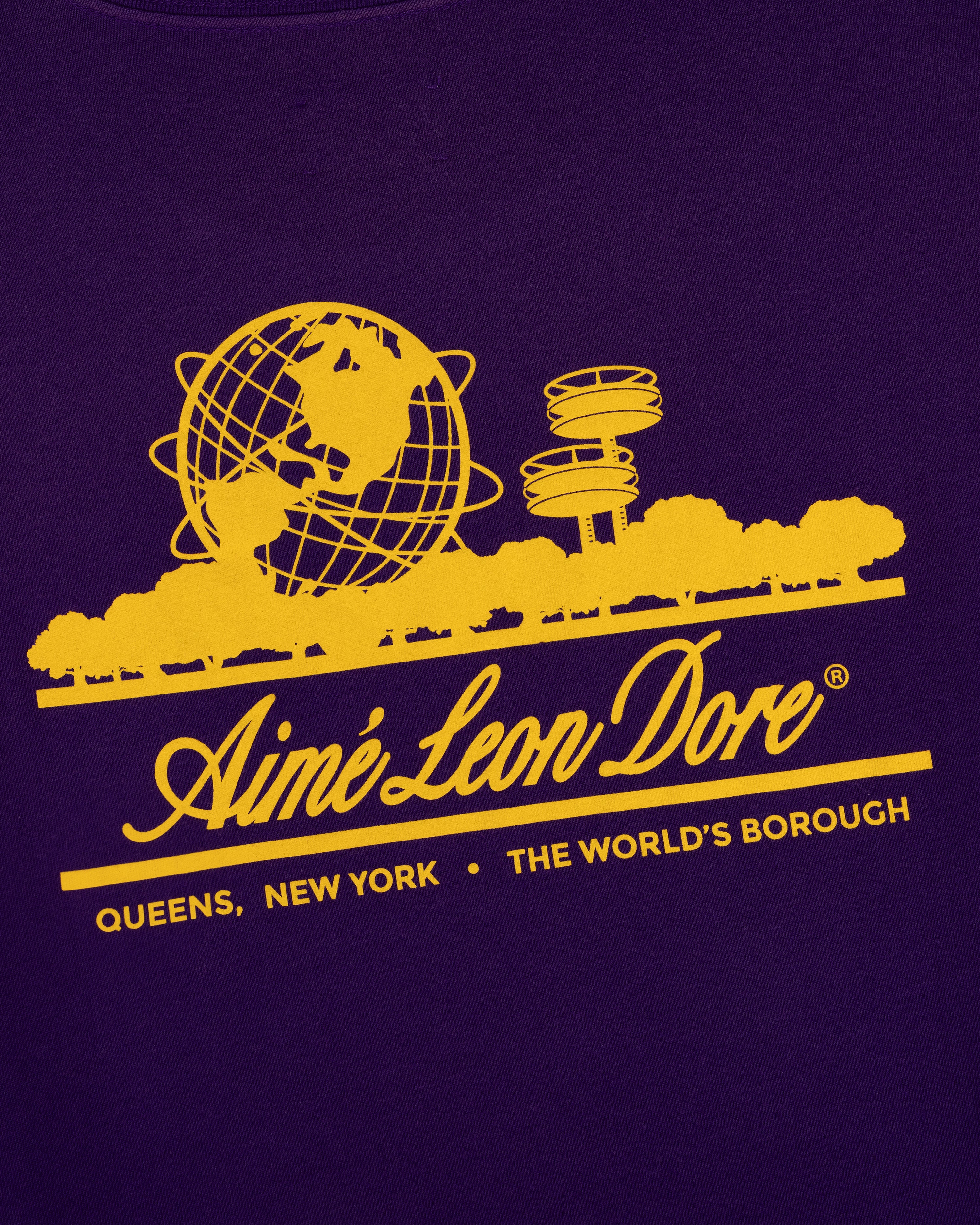 Yellow graphic with globe, trees & towers above “Aimé Leon Dore, Queens, NY” on purple Sun Faded Unisphere Tee.