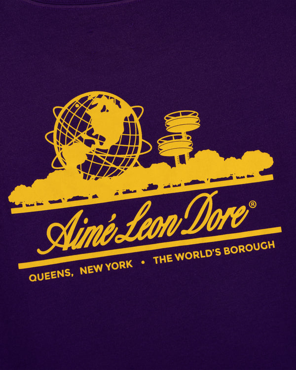 Yellow graphic with globe, trees & towers above “Aimé Leon Dore, Queens, NY” on purple Sun Faded Unisphere Tee.