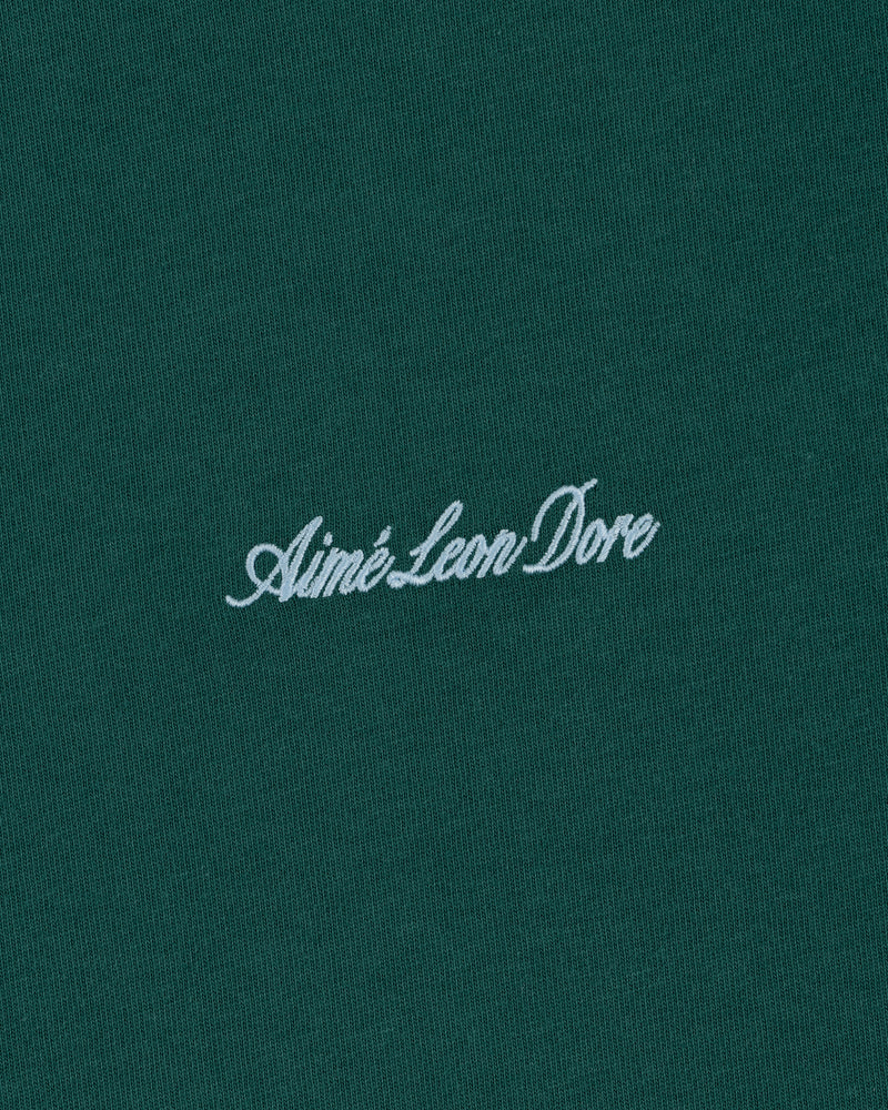 White Aimé Leon Dore script logo embroidered on dark green Embroidered Logo Tee.