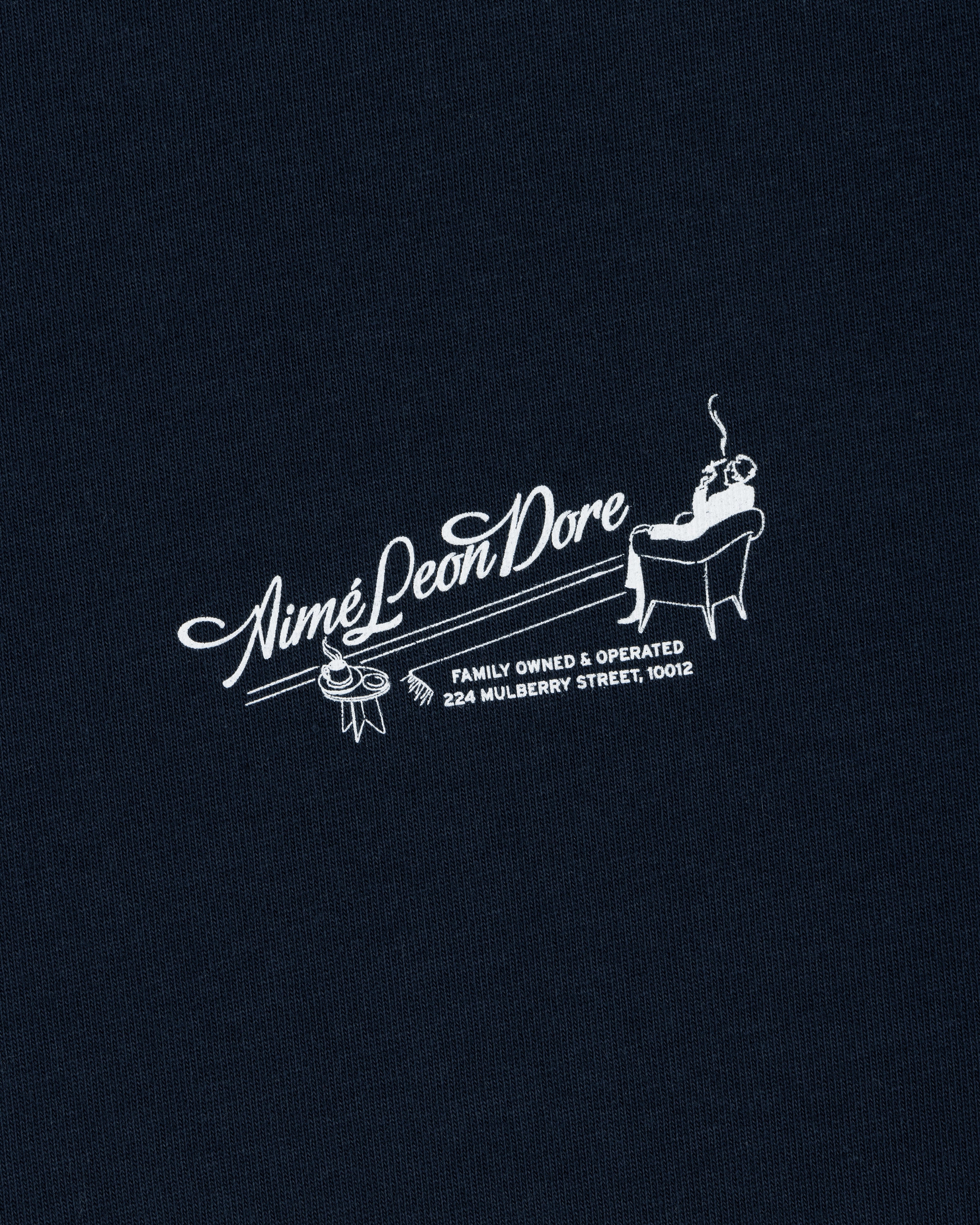 The Pappoús Logo Tee features "Aimé Leon Dore" with a man lounging and address 224 Mulberry Street, 10012 below.