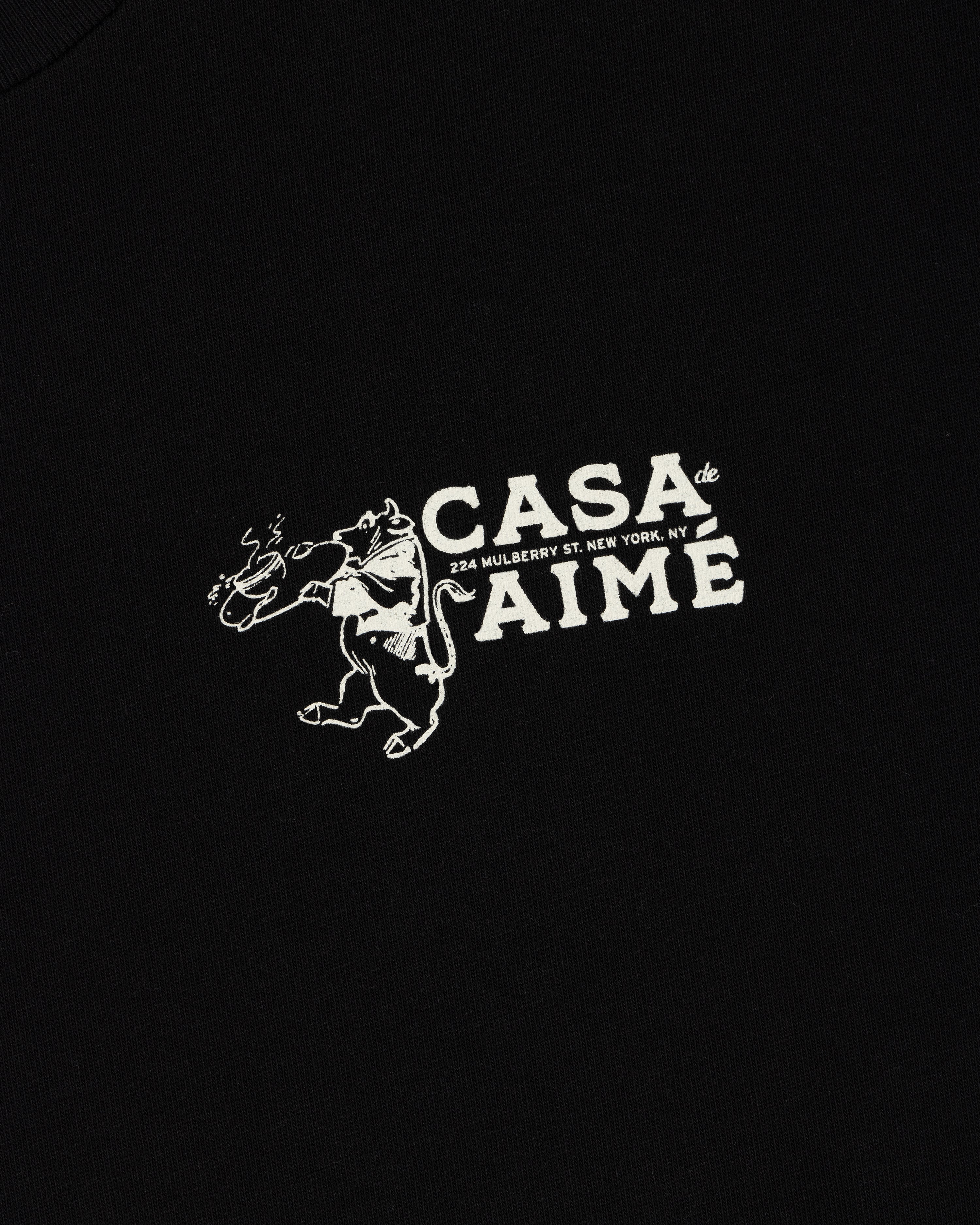 Long-Sleeve Casa Tee: Black with white graphic of a bull holding a rose, “Casa de Aime, 224 Mulberry St. New York, NY.”.