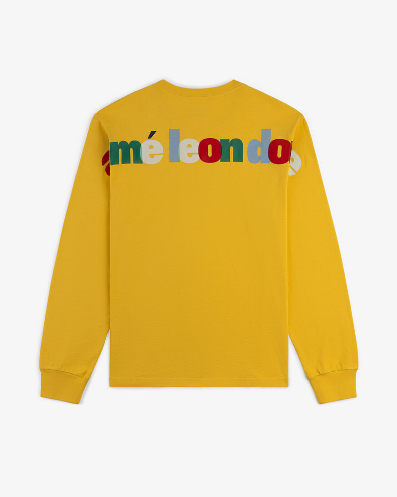 Yellow Long-Sleeve Souvenir Tee with colorful, overlapping méleondo letters across the upper back.