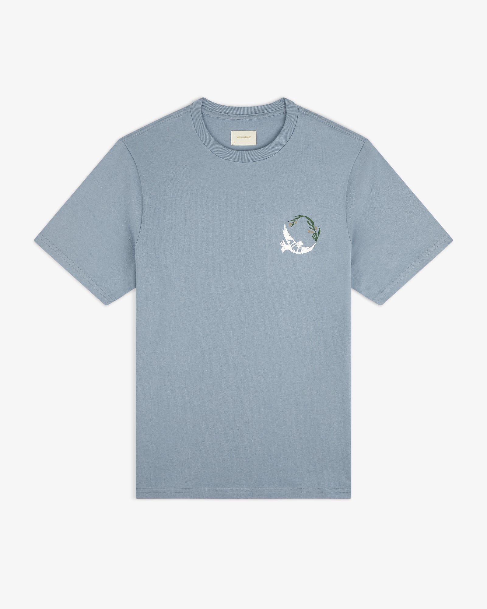Woodblock Dove Tee: light blue short-sleeve shirt with a white bird and green leaf graphic on the left chest.