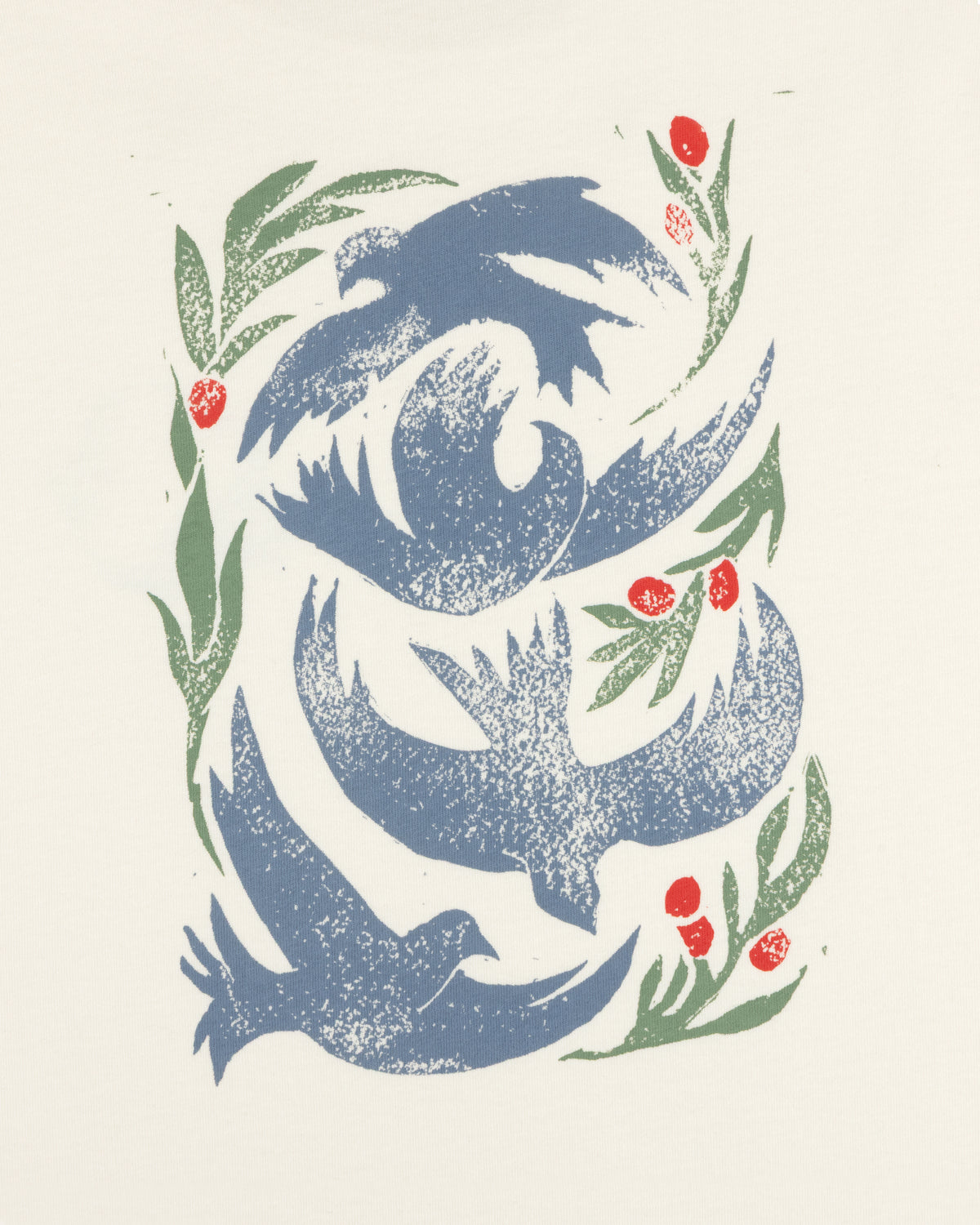 Woodblock Dove Tee features blue birds flying among green leaves and red berries on a cream background.
