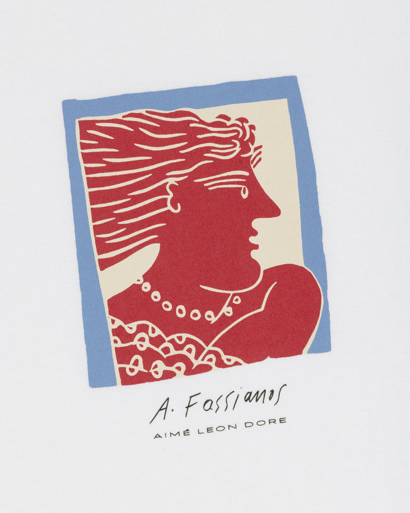 The Fassianos Portrait Tee features a red Greek-style profile with flowing hair, framed in blue, signed by A. Fassianos.