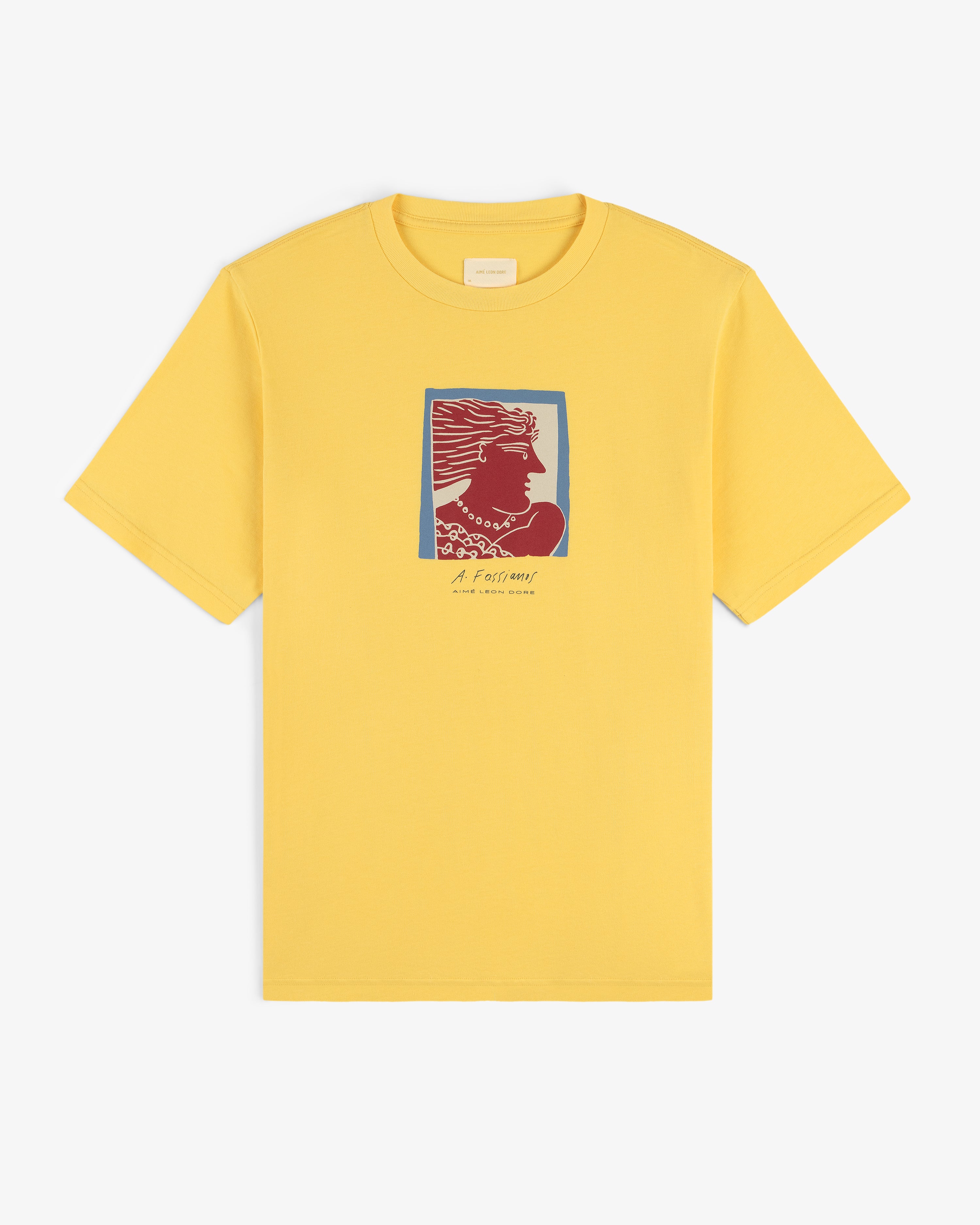 Fassianos Portrait Tee: yellow shirt with a red and blue woman’s profile and small text beneath the chest image.