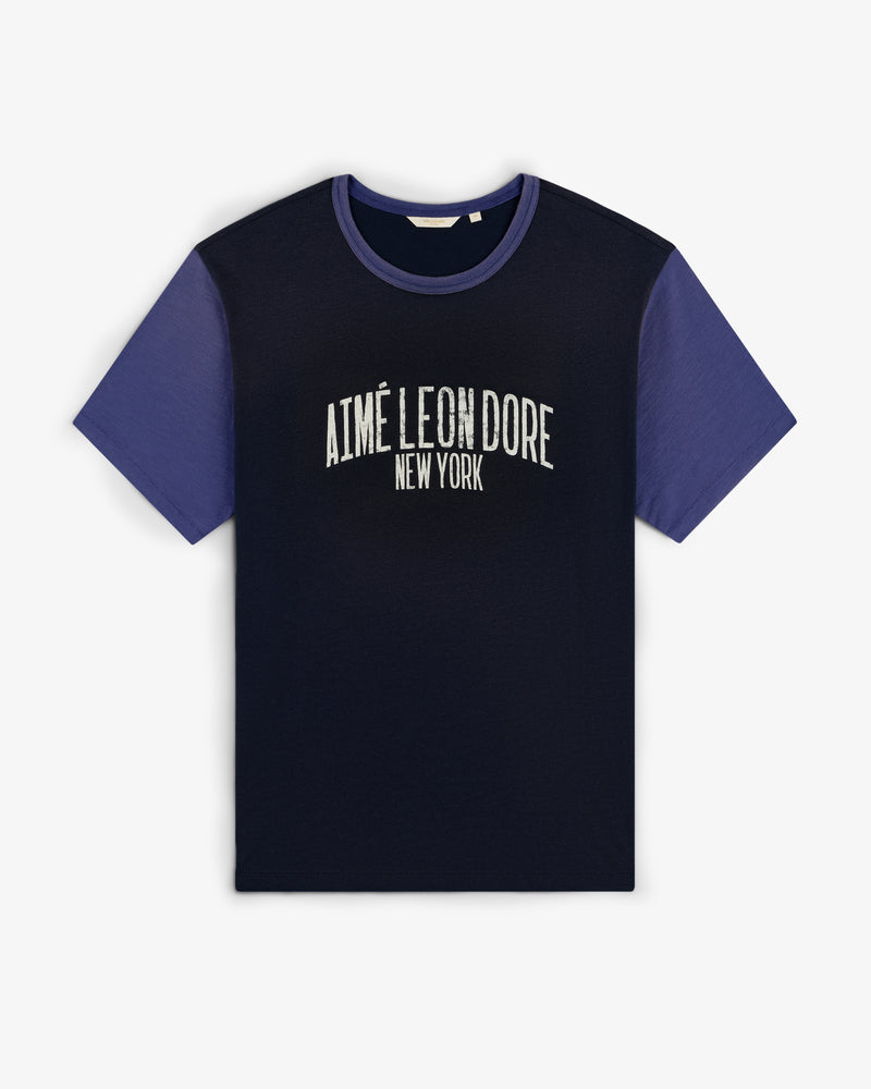 Washed Ringer Tee in navy blue, purple sleeves, white AIMÉ LEON DORE NEW YORK print on chest.