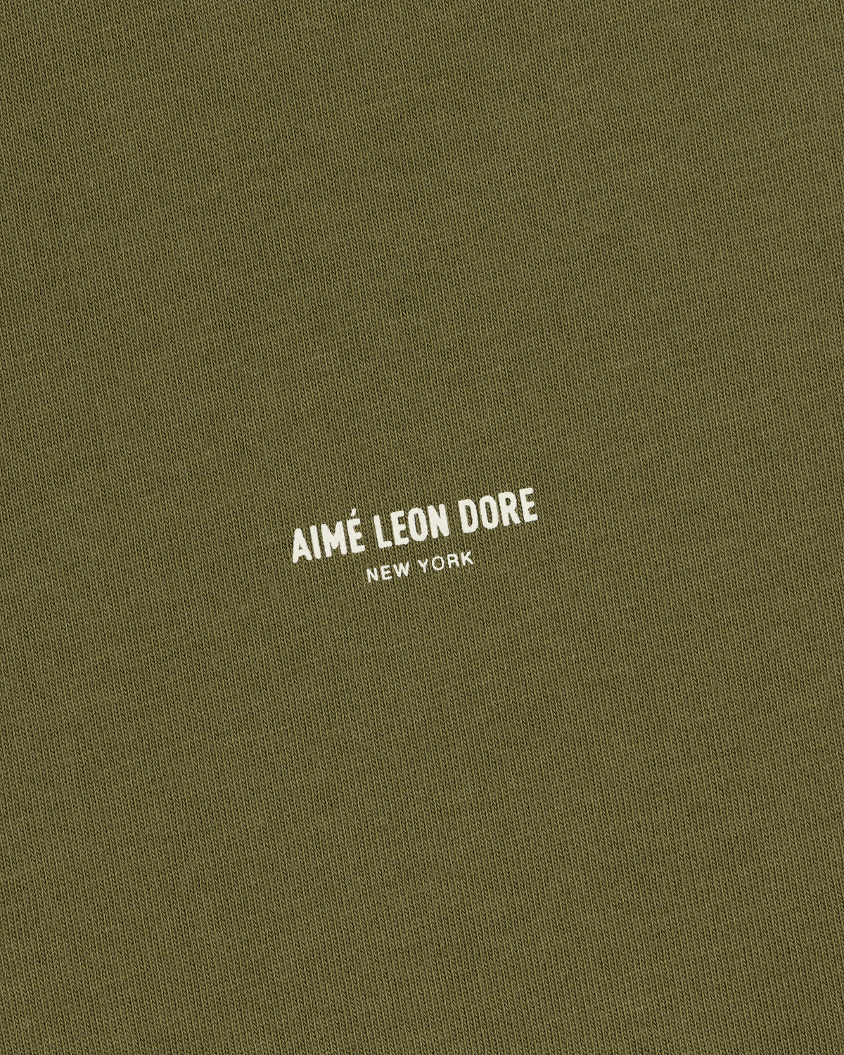Safari Tee in olive green with AIMÉ LEON DORE NEW YORK printed in small white uppercase letters at the center.