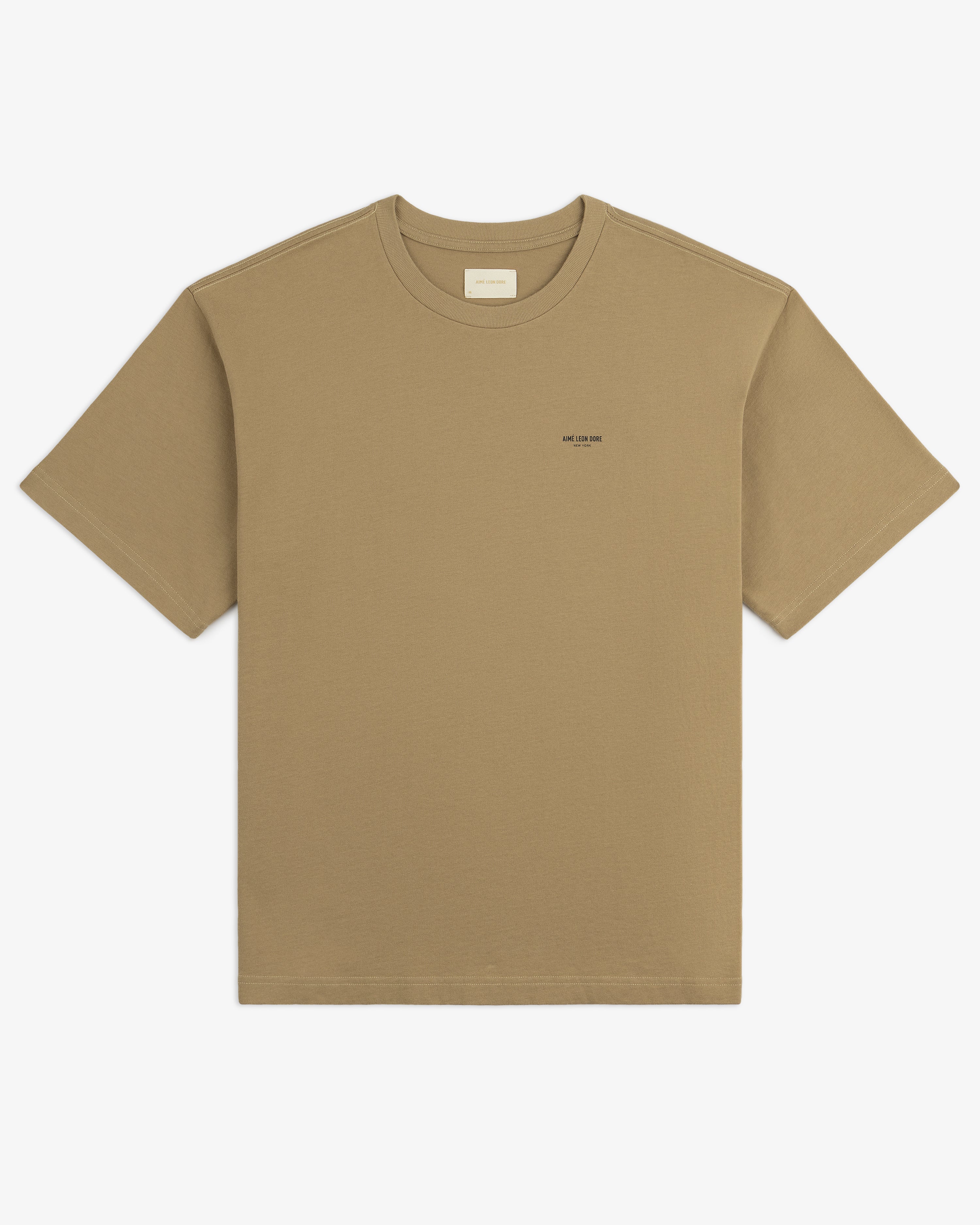 Safari Tee: tan short-sleeve shirt with a small chest logo, shown flat on a white background.