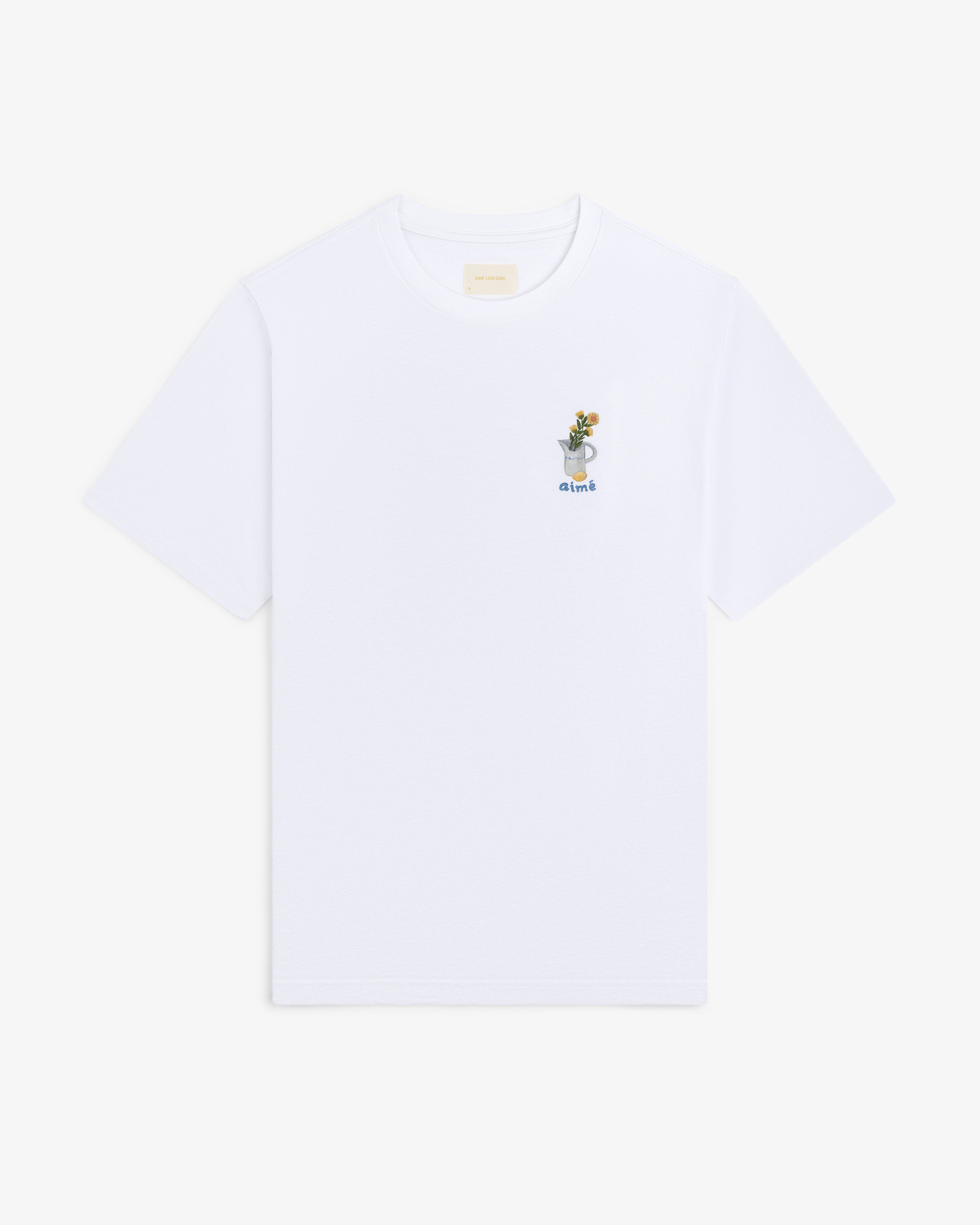 Breakfast Tee: White shirt with small embroidered plant in a cup and "drink" on upper left chest.