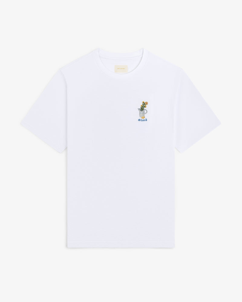 Breakfast Tee: White shirt with small embroidered plant in a cup and "drink" on upper left chest.