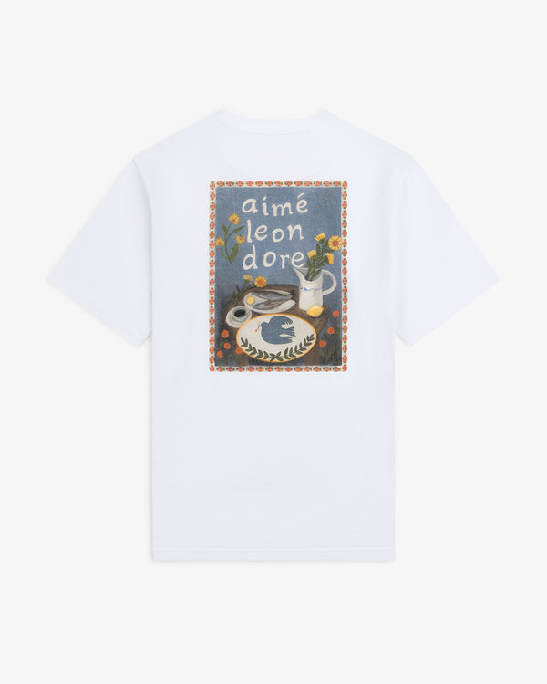 Breakfast Tee featuring a colorful graphic of flowers, vase, and food, with “aimé leon dore” text on the back.