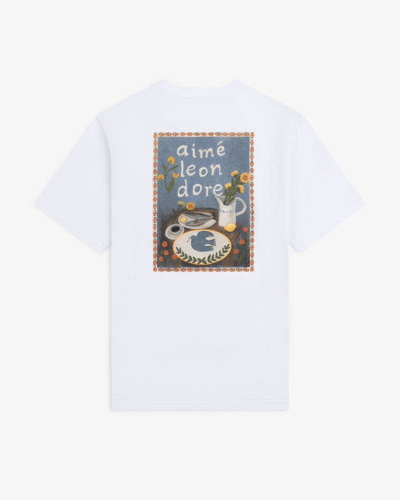 Breakfast Tee featuring a colorful graphic of flowers, vase, and food, with “aimé leon dore” text on the back.