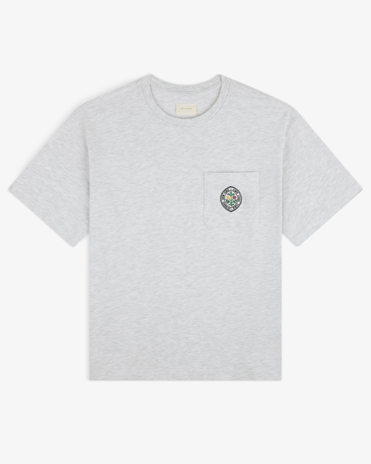 Light gray Botanical Crest Pocket Tee with short sleeves and a chest pocket featuring a small colorful crest.