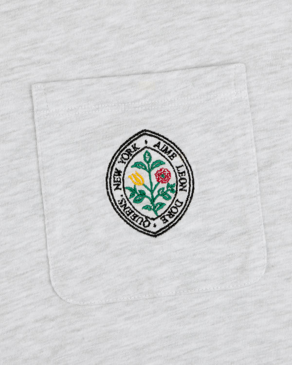 Botanical Crest Pocket Tee with a circular floral patch and “Aime Leon Dore New York Queens” text on the pocket.