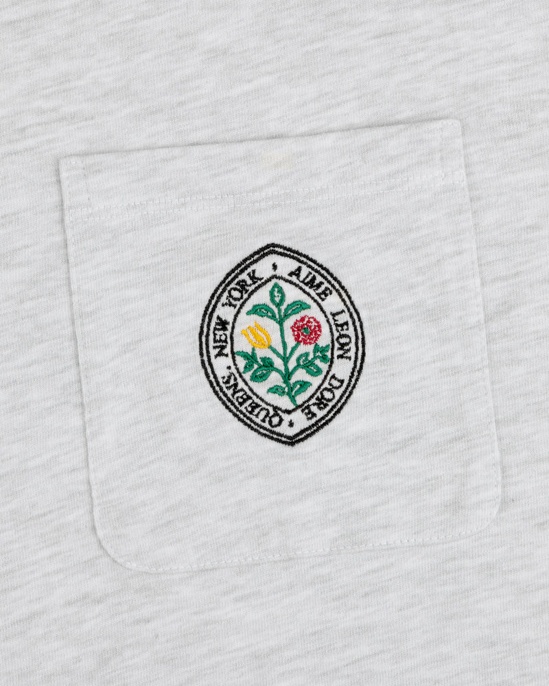 Botanical Crest Pocket Tee with a circular floral patch and “Aime Leon Dore New York Queens” text on the pocket.