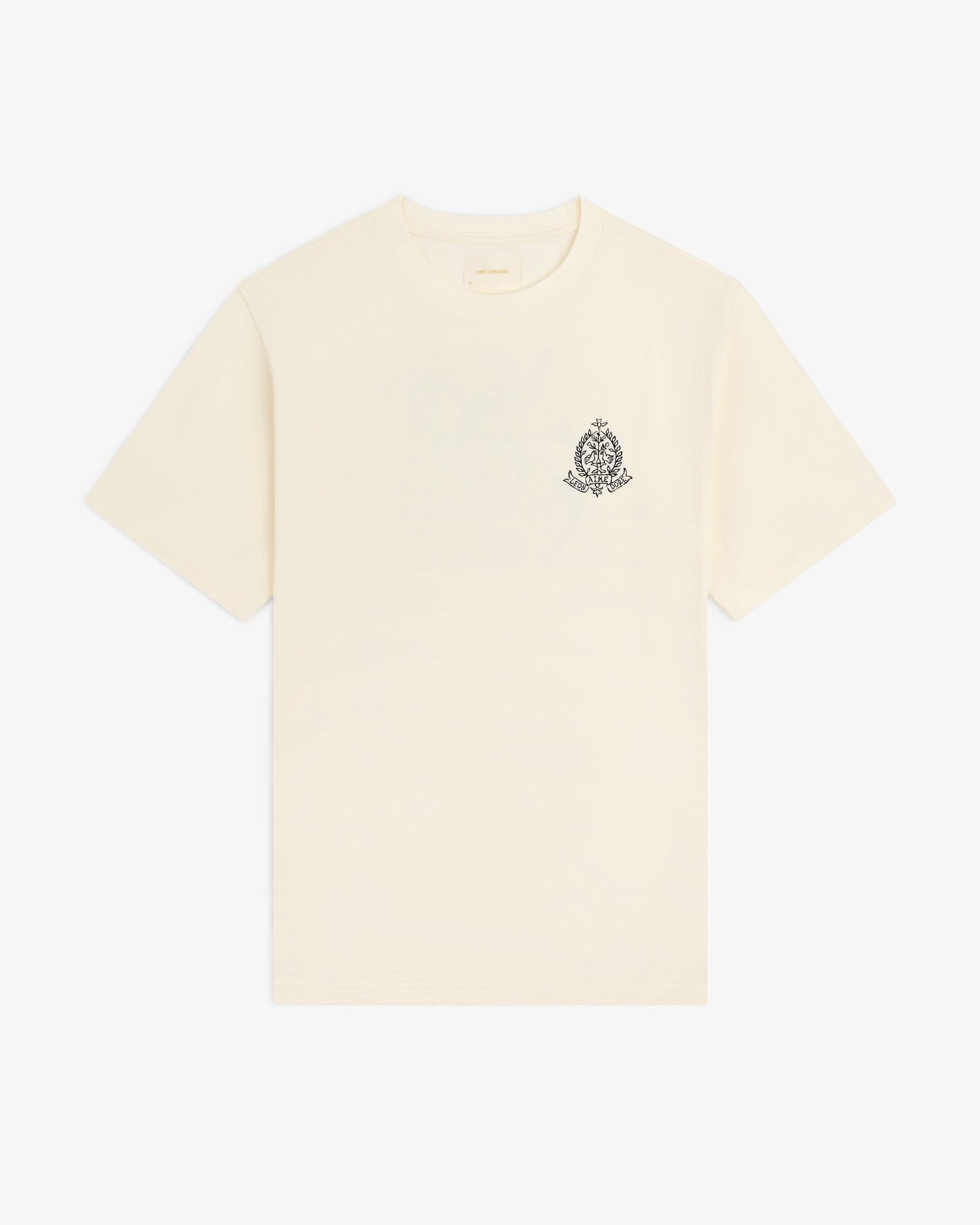 Saint George Graphic Tee: cream short-sleeve t-shirt with a small black ornate crest on the upper left chest.