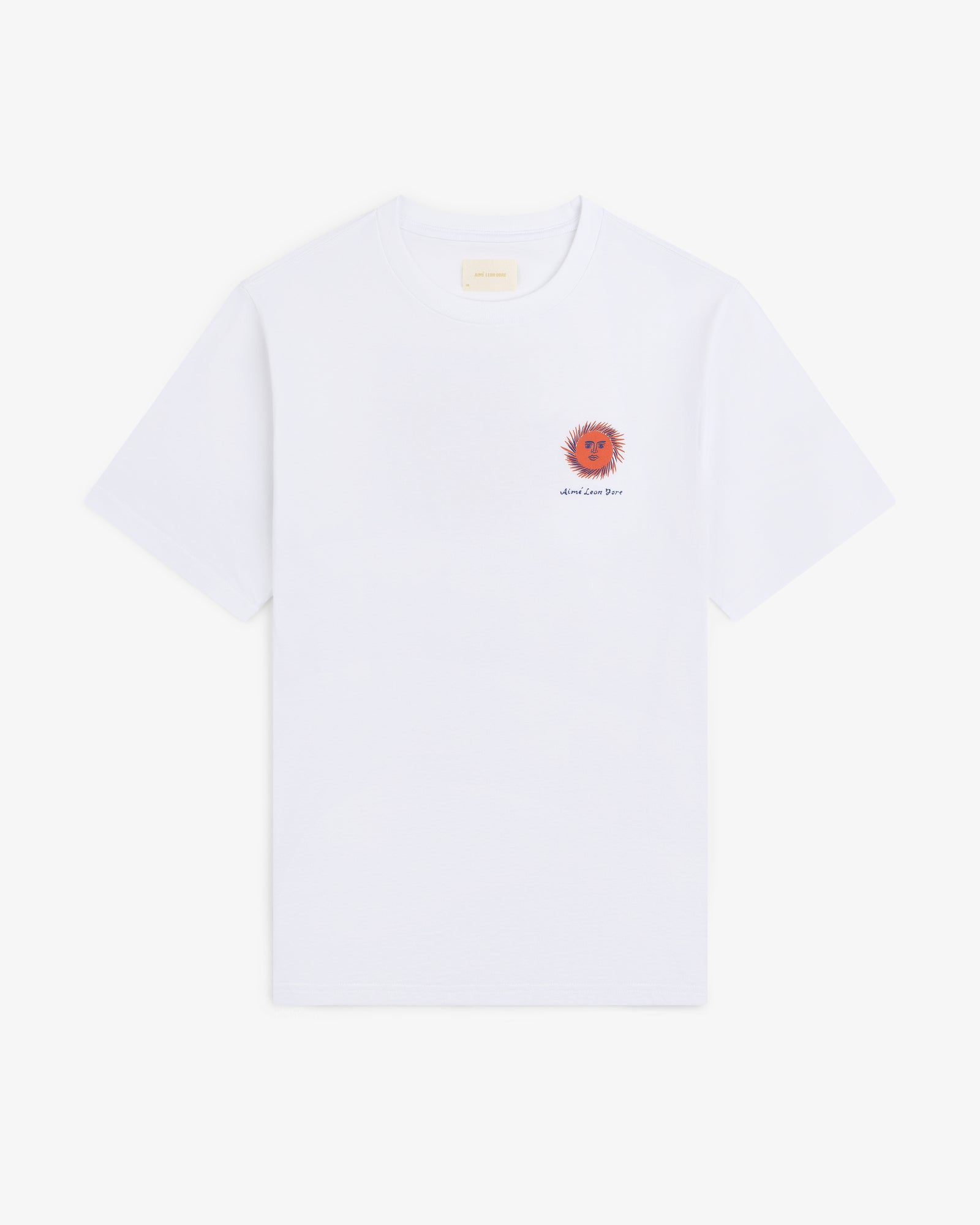 Fassianos "Sovereign Sun" Tee: white t-shirt with small red-orange sun and text on left chest, shown on plain background.
