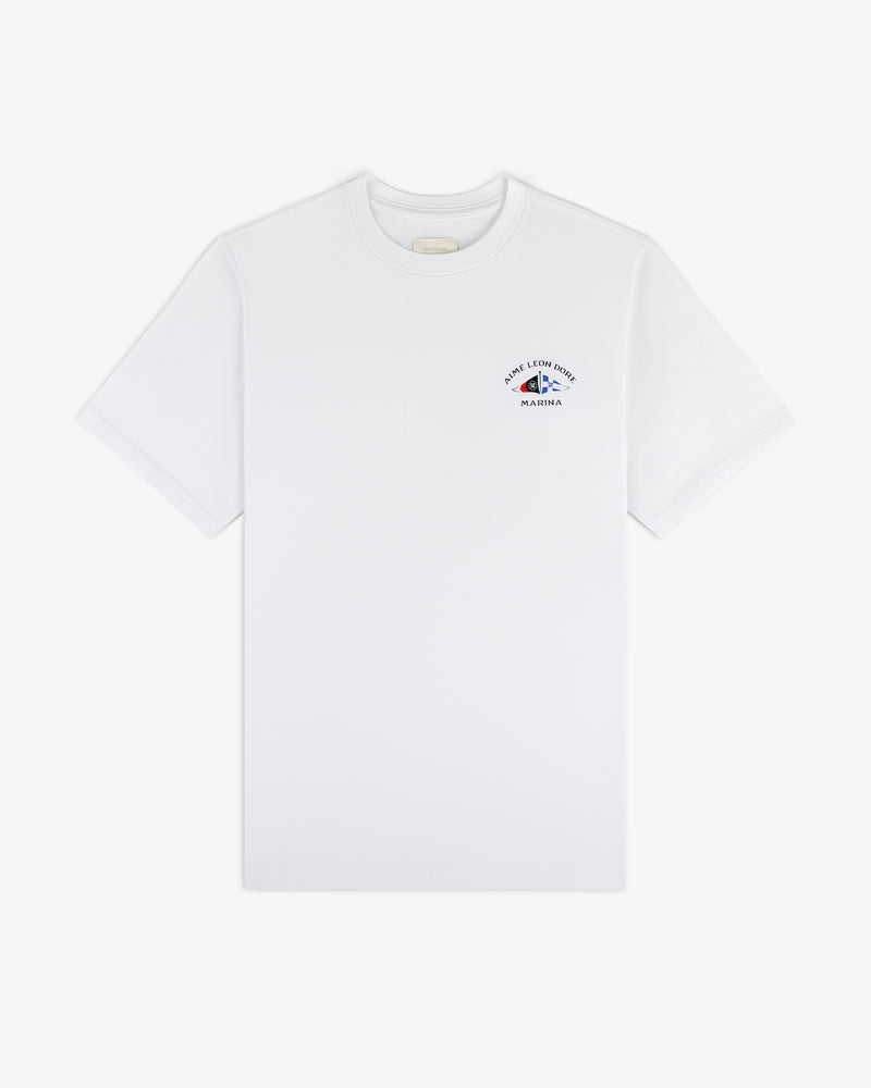 Marina Tee: white short-sleeve shirt with small blue graphic and text on upper left chest.