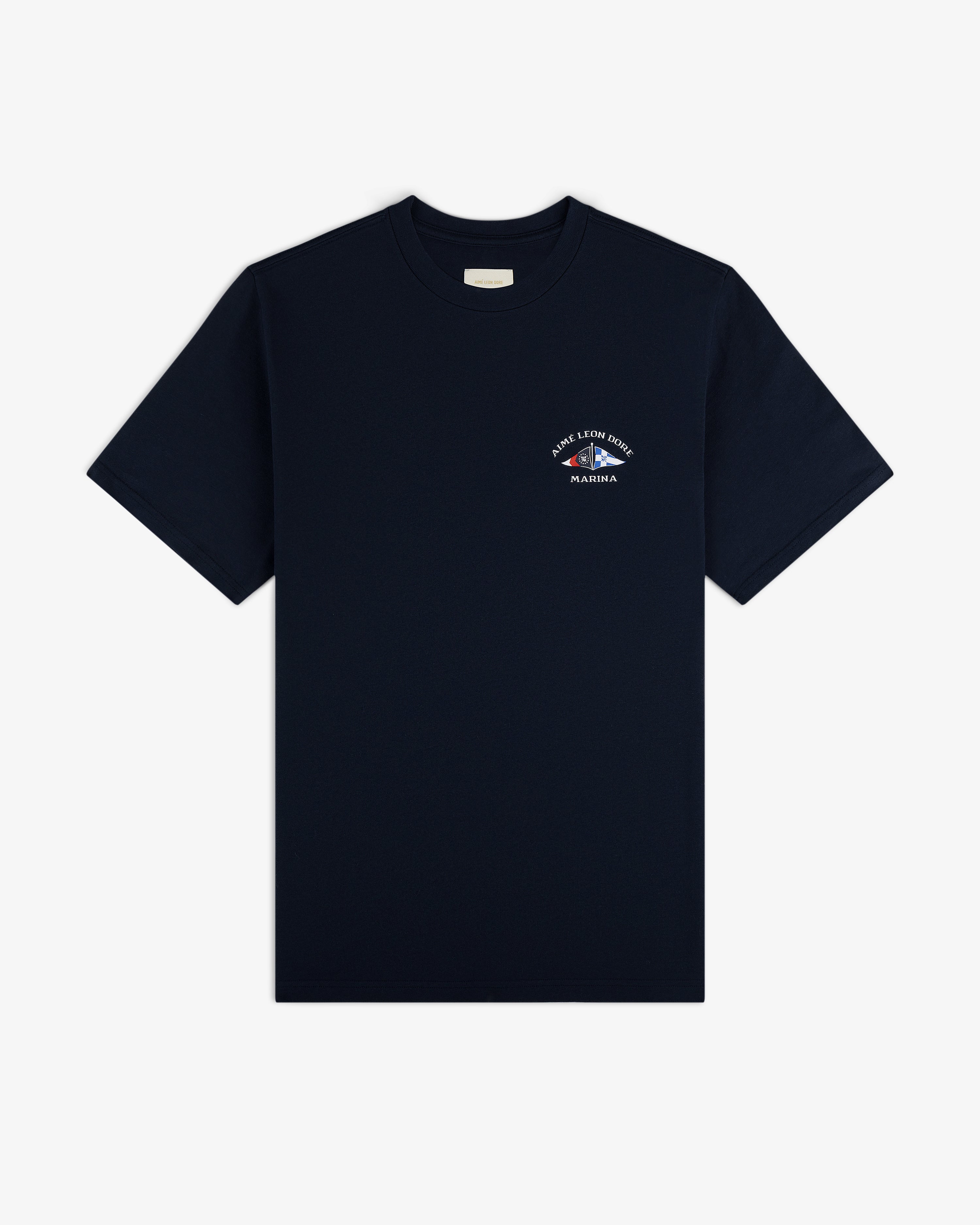 The Marina Tee is a plain black shirt with a small white graphic and text on the left chest, shown on a white background.