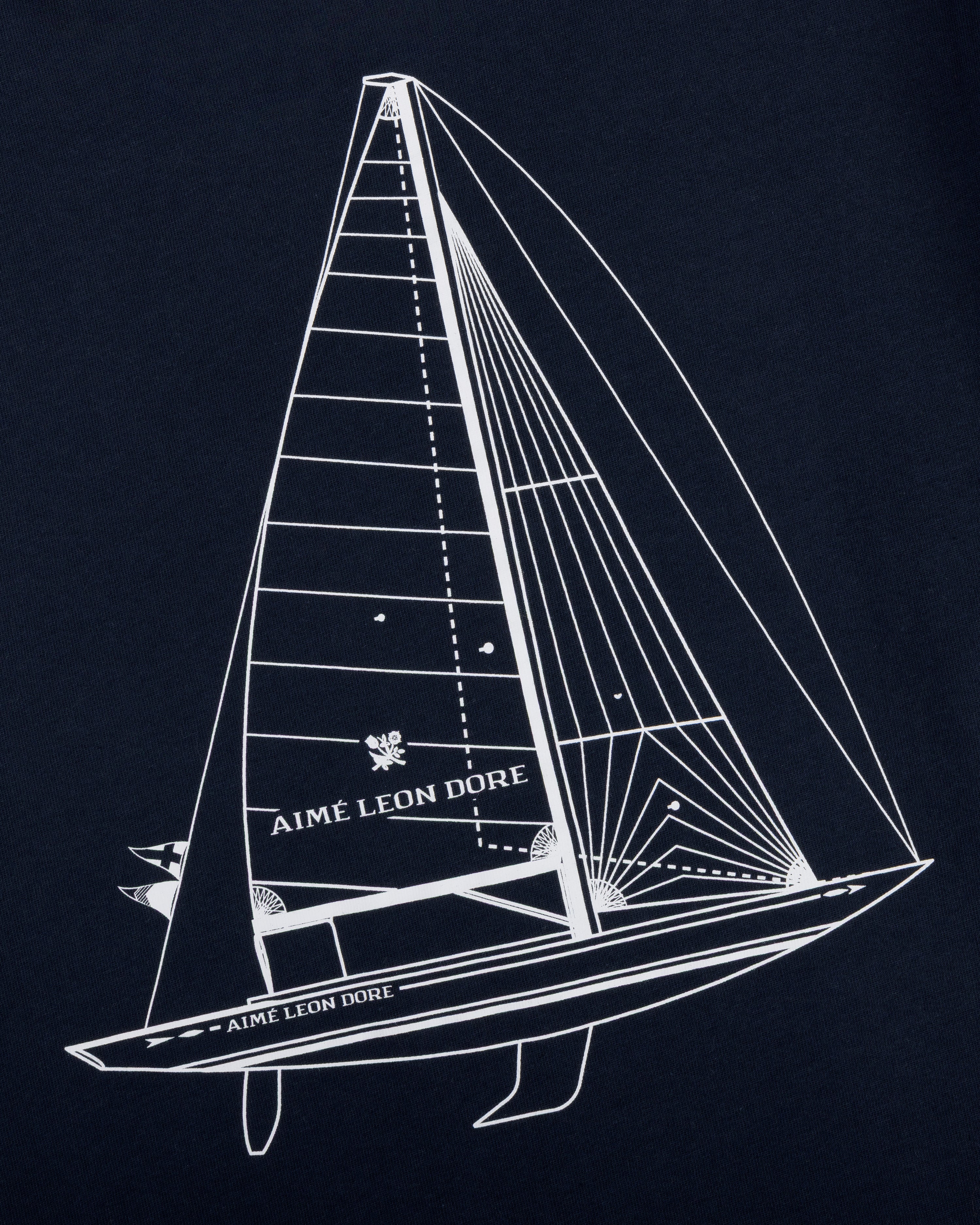 White line sailboat and AIMÉ LEON DORE text on dark blue Marina Tee.