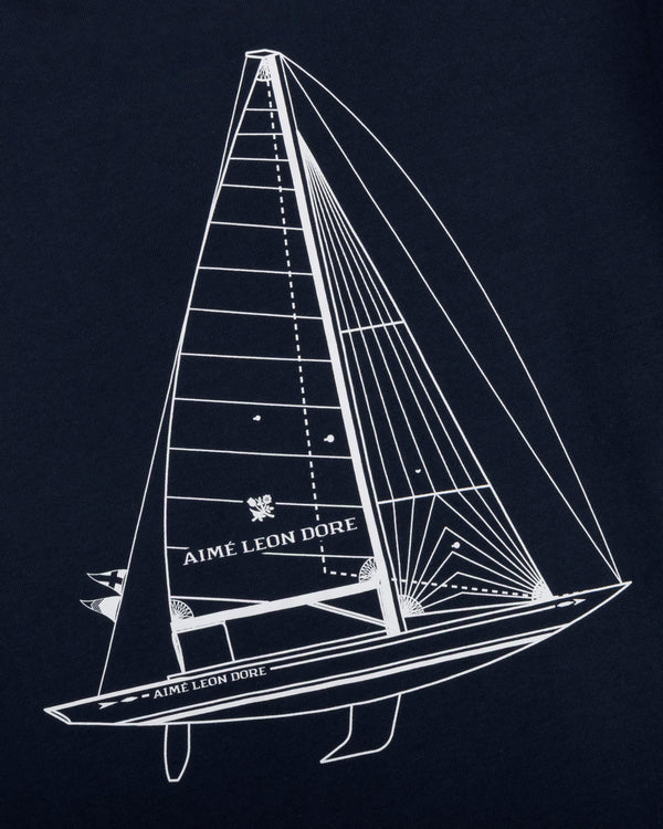 White line sailboat and AIMÉ LEON DORE text on dark blue Marina Tee.