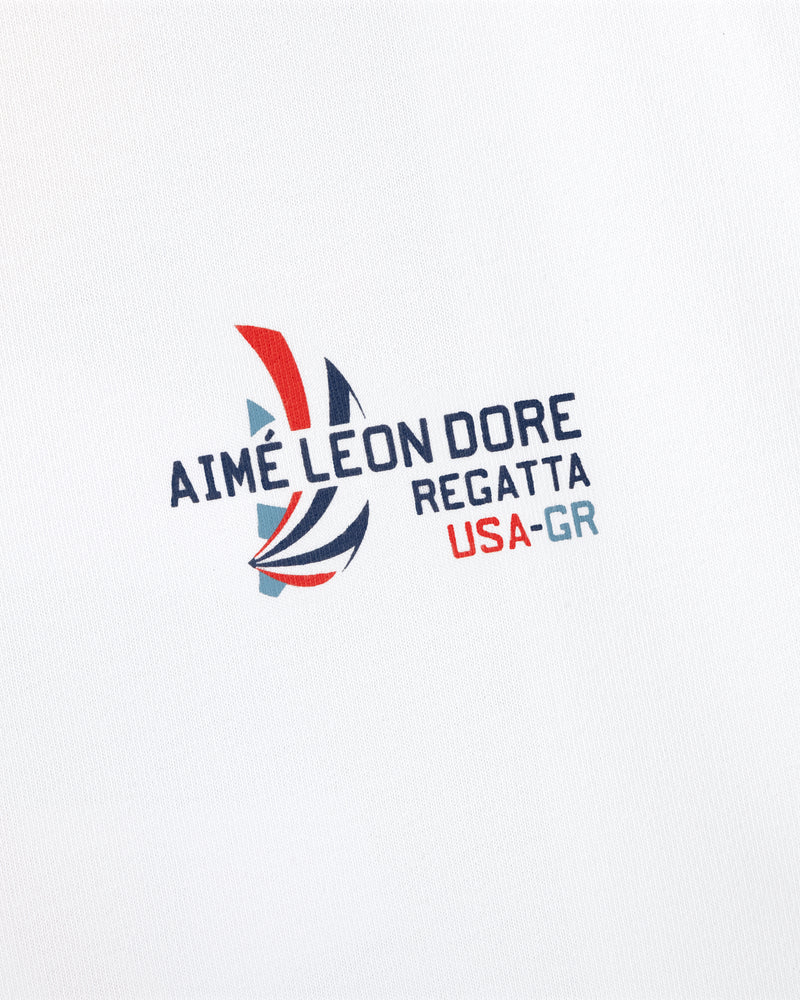 Regatta Tee with Aimé Leon Dore sailboat logo and USA-GR text on a white background.