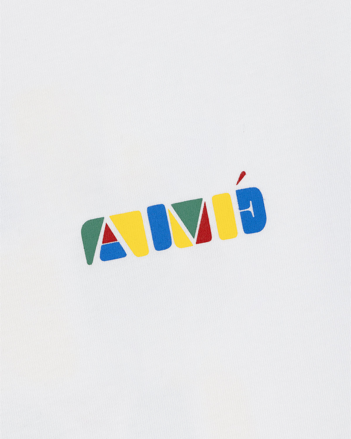 Stacked Logo Tee featuring colorful geometric letters spelling AMÉ on a white background.