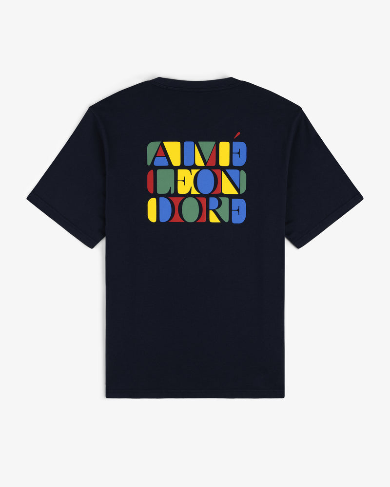 Stacked Logo Tee in navy with colorful geometric AIMÉ LEON DORE text design on the back.
