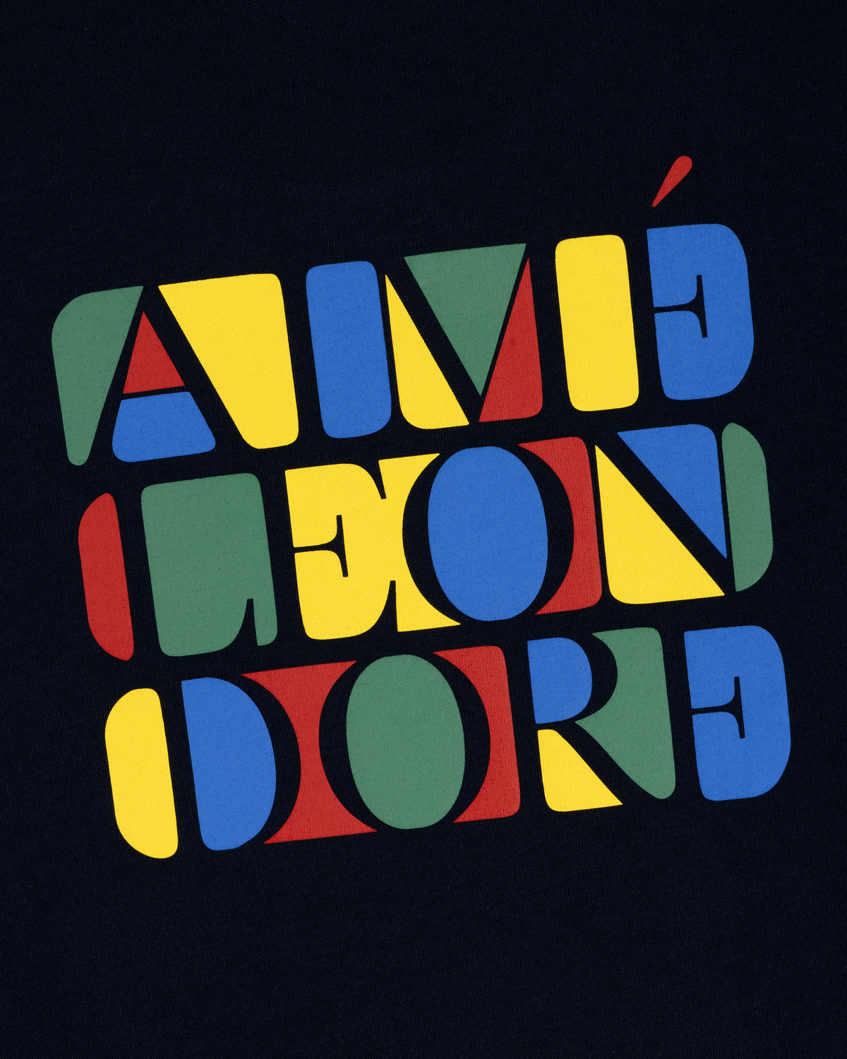 Bold, colorful “Stacked Logo Tee” text in red, yellow, blue, and green geometric letters on a black background.