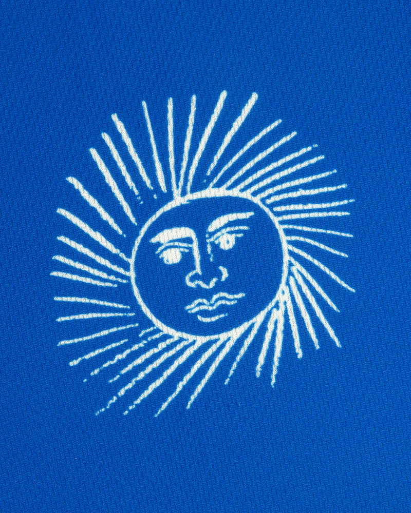 The Fassianos Half-Zip Cycling Jersey features a white sun with a face and rays on a bright blue background.