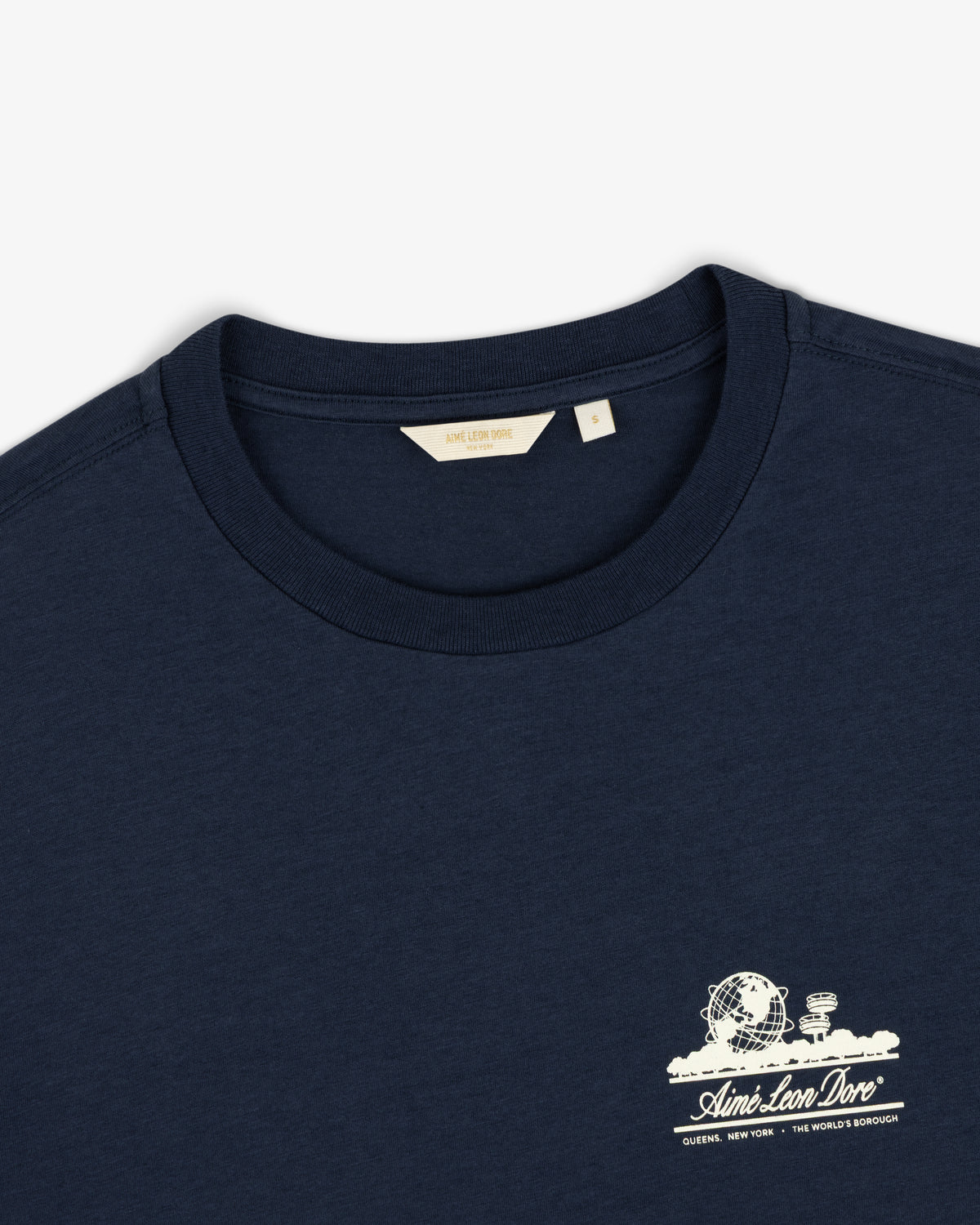 Cropped Aloe-Blend Unisphere Tee in navy with small white graphic and Aimé Leon Dore text on left chest, size S.