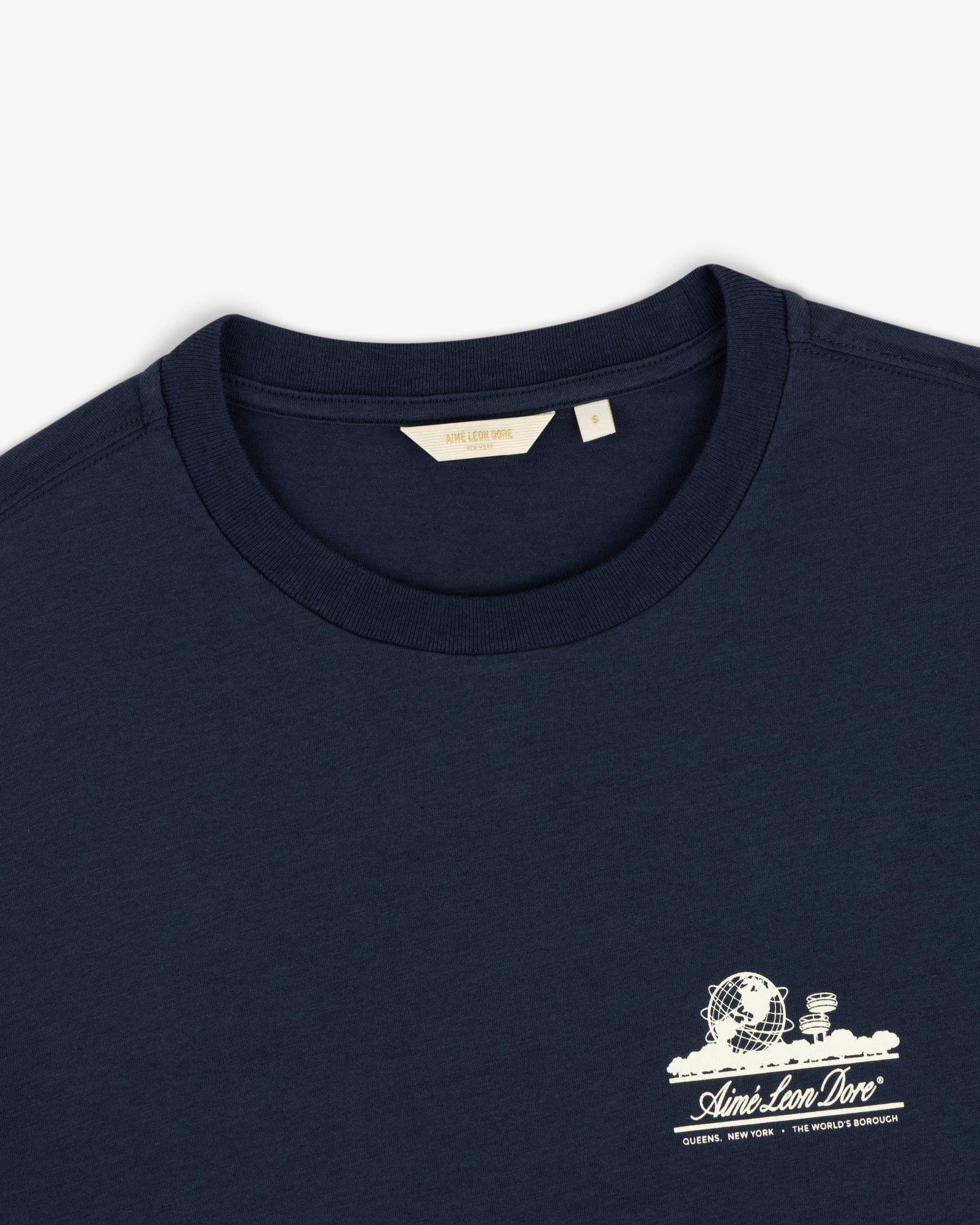 Cropped Aloe-Blend Unisphere Tee in navy with small white graphic and Aimé Leon Dore text on left chest, size S.