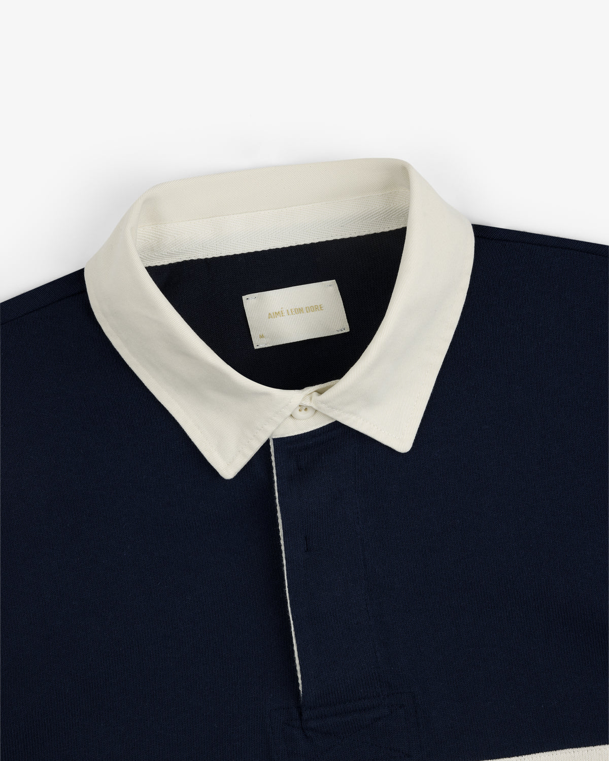 Navy Script Paneled Rugby with a white pointed collar and interior neckline label.