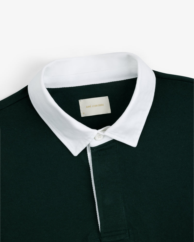 Dark green Script Paneled Rugby with a white collar and an inside label reading ACME LION DESIGN.
