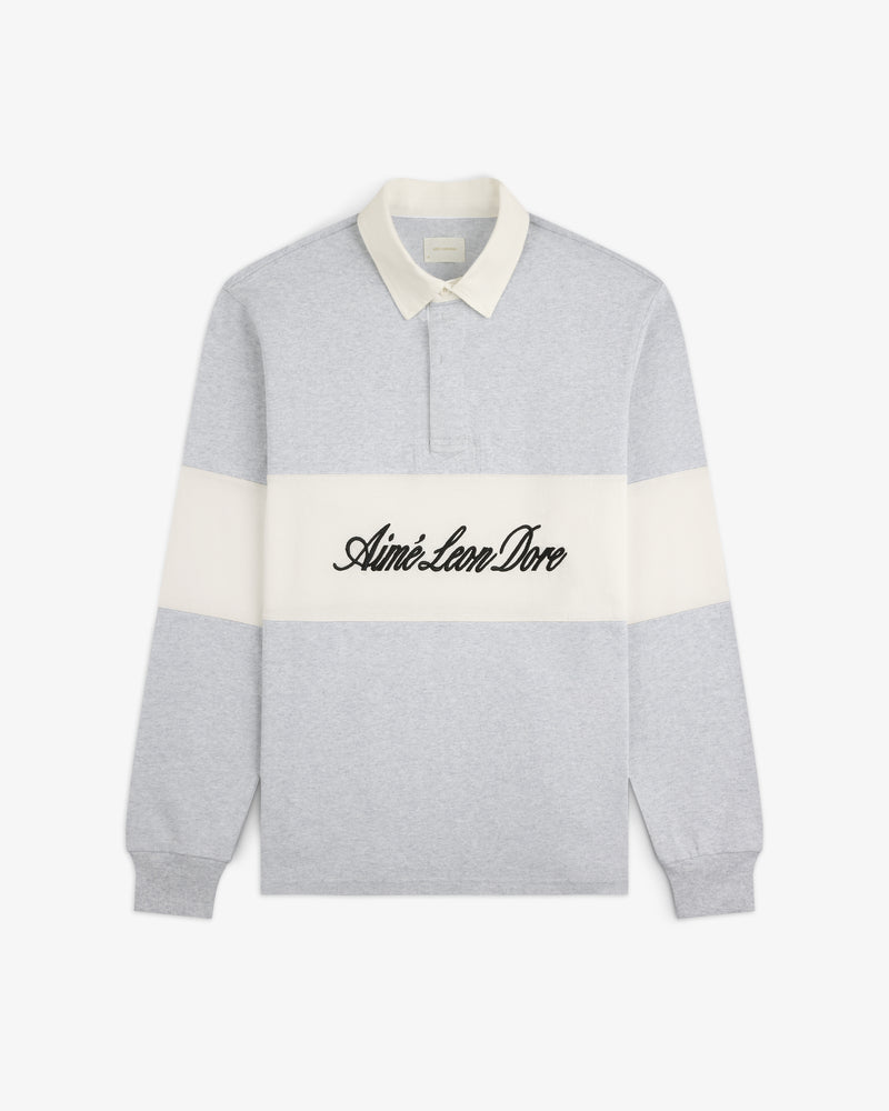 Light gray Script Paneled Rugby with white collar, stripe, and Aimé Leon Dore text in black script across the chest.