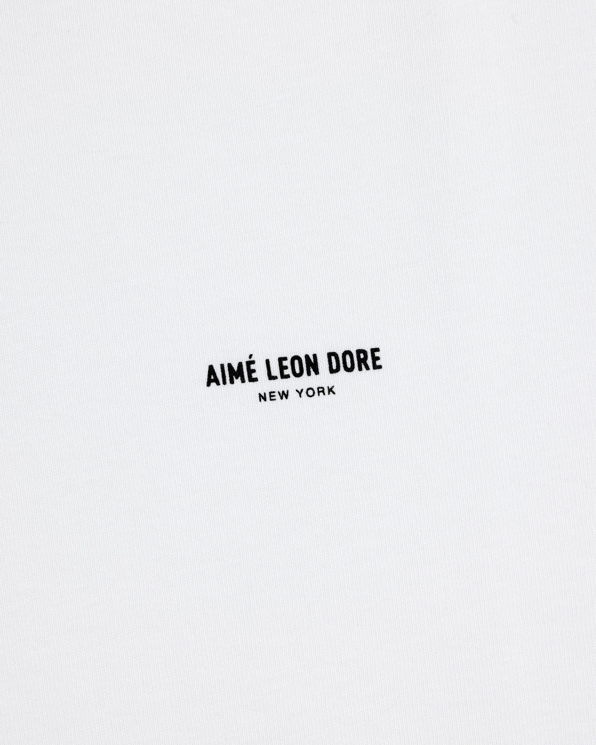 White Long-Sleeve Micro Logo Tee with small black "AIMÉ LEON DORE" text and "NEW YORK" below in the center.