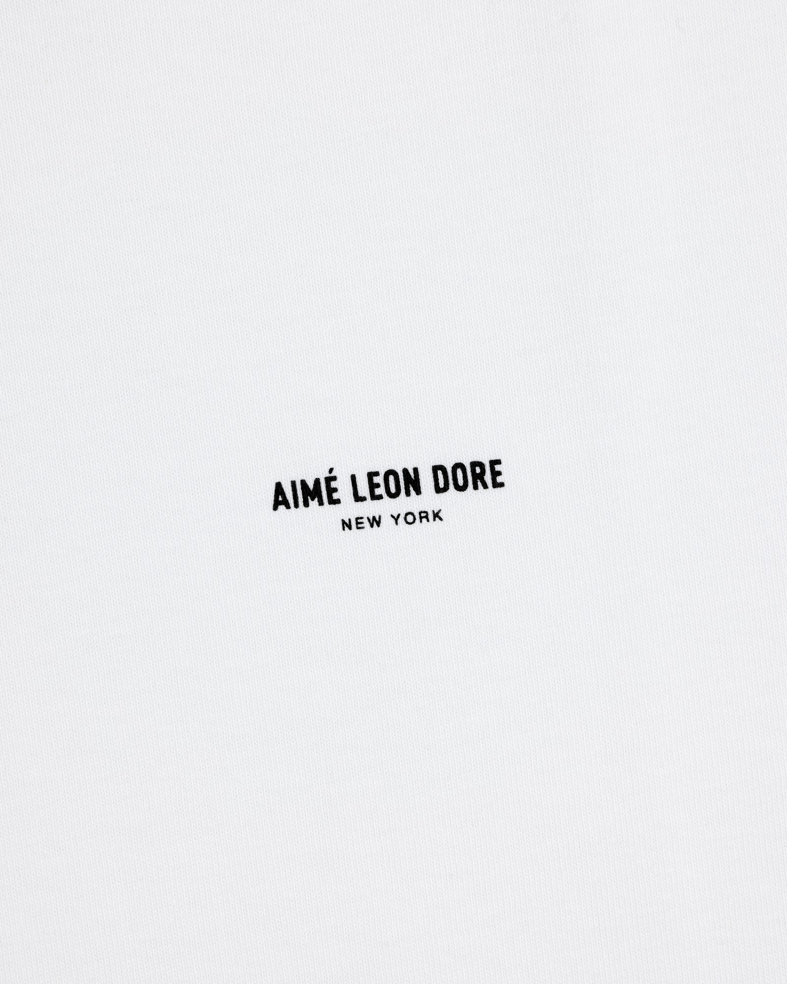 White Long-Sleeve Micro Logo Tee with small black "AIMÉ LEON DORE" text and "NEW YORK" below in the center.
