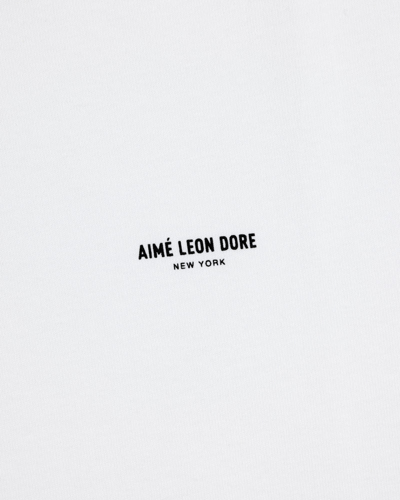 White Long-Sleeve Micro Logo Tee with small black "AIMÉ LEON DORE" text and "NEW YORK" below in the center.