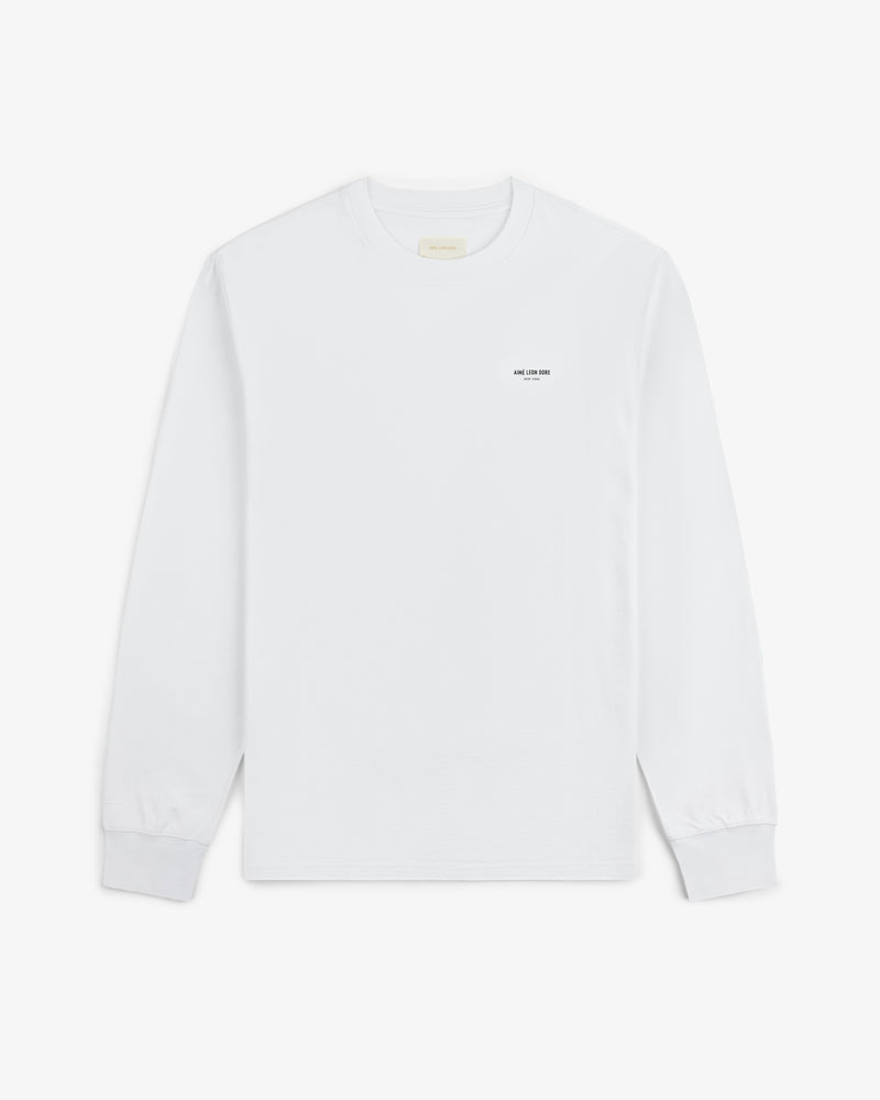 Long-Sleeve Micro Logo Tee: white crewneck with small black text on the left chest.