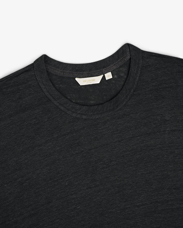 A close-up of a dark gray Linen Tee crew-neck with a visible size and brand tag inside the collar.