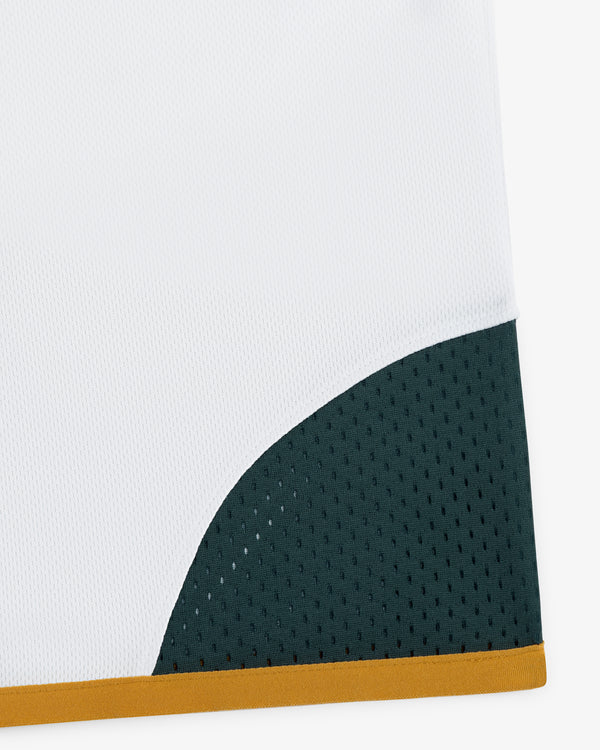 The ALD / Technics Soccer Jersey features white fabric, a dark green mesh section, and a yellow border at the bottom right.