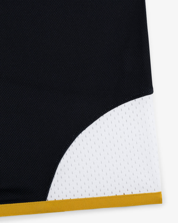 Closeup of the ALD / Technics Soccer Jersey in black and white fabric with a yellow border.