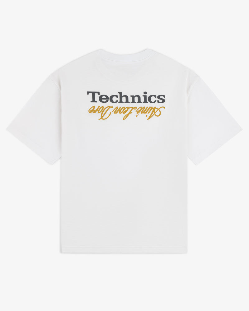 The ALD / Technics Logo Tee is a white T-shirt with "Technics" and "Online Team One" upside down on the back in black and gold.